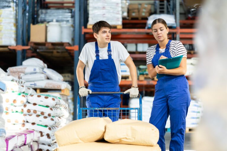 Image of two staff in a chemical warehouse